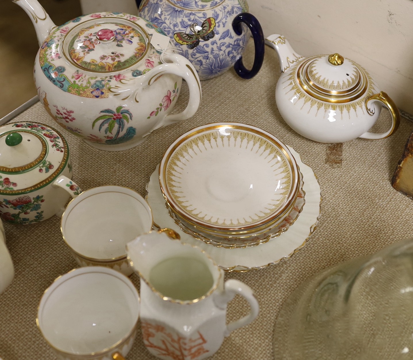 A quantity of tea pots and wares including Doulton, Royal Chelsea, etc.